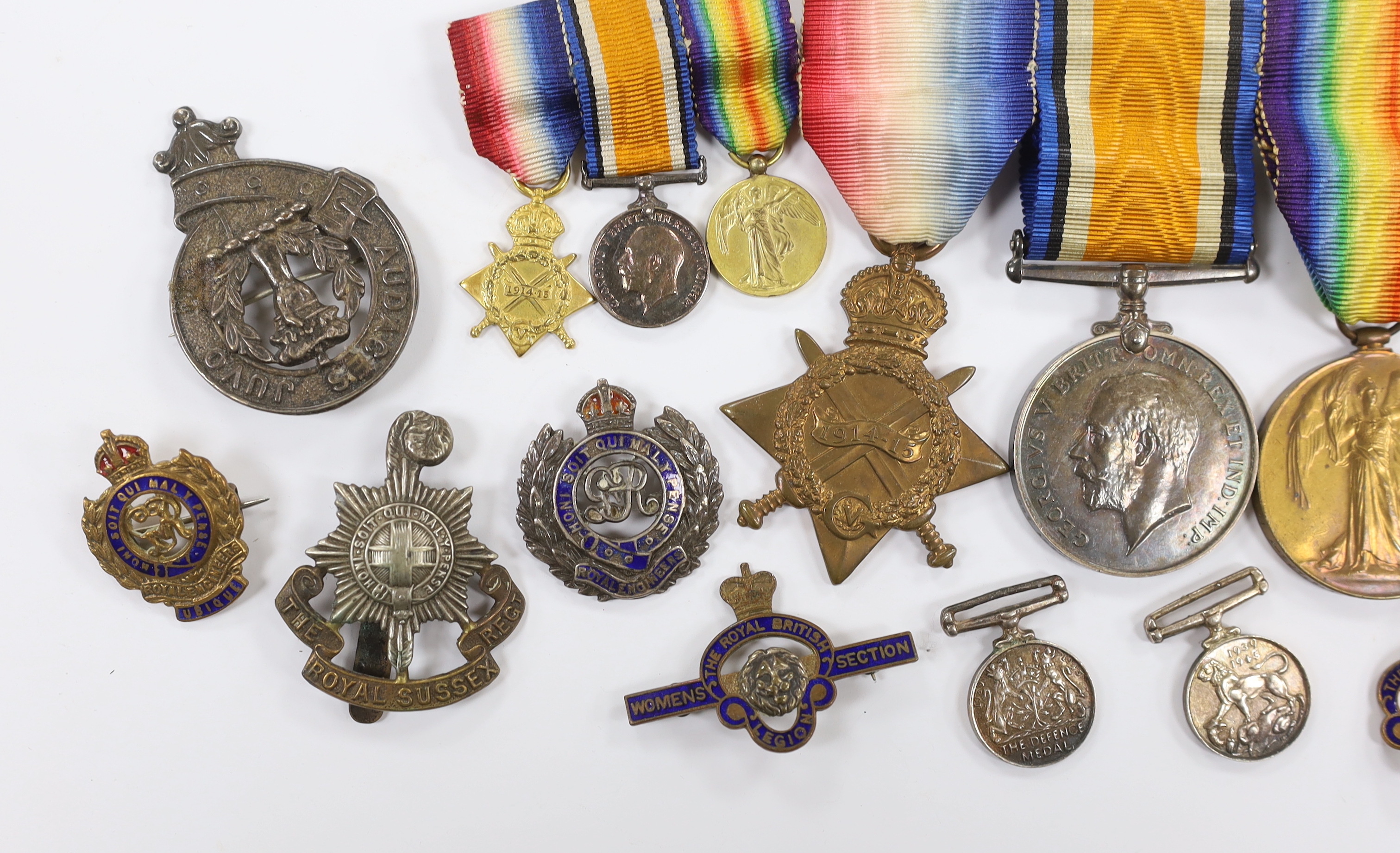 A WWI trio to Pte. W.K. Scudamore R.A.M.C. and miniatures, four WWII miniatures, five lapel badges, a silver Royal Engineers badge a Royal Sussex Reg. cap badge and a Norfolk Reg. cap badge